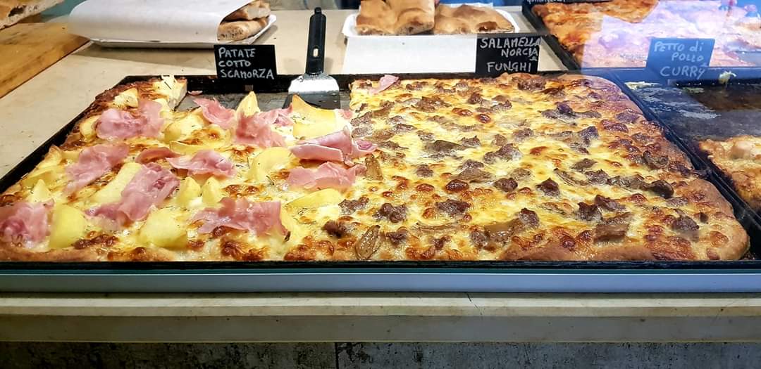 Slices of pizza in the bakery display